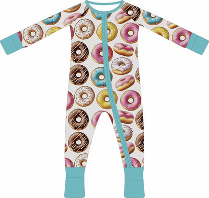 Children's jammies with donut pattern and turquoise accents on a white background