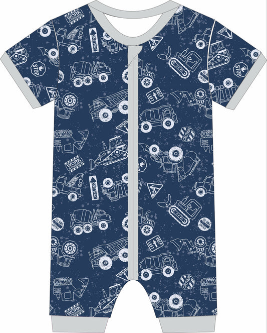 Children's jammies with construction vehicle pattern on a blue background
